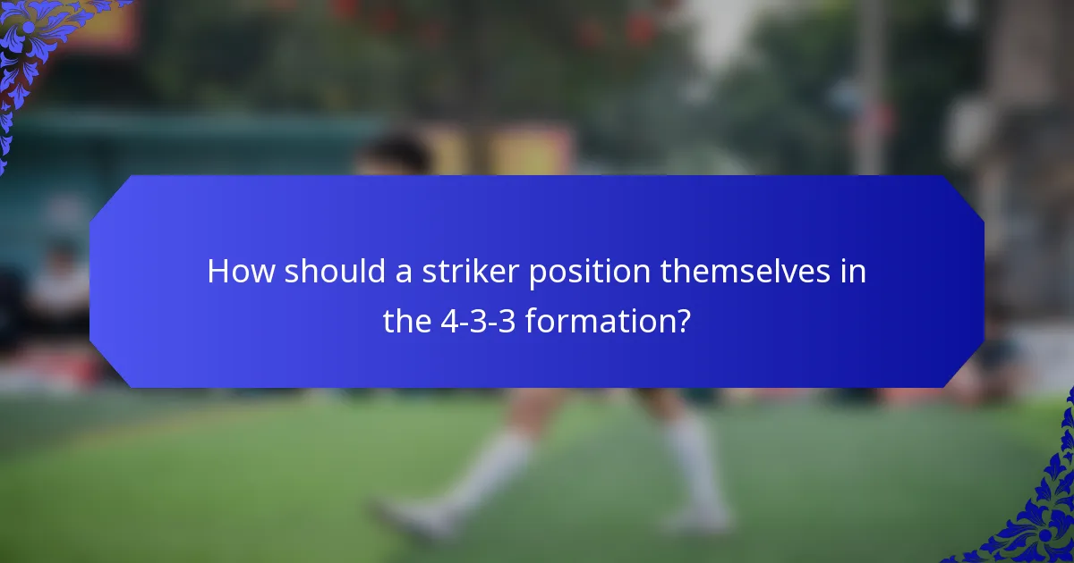 How should a striker position themselves in the 4-3-3 formation?